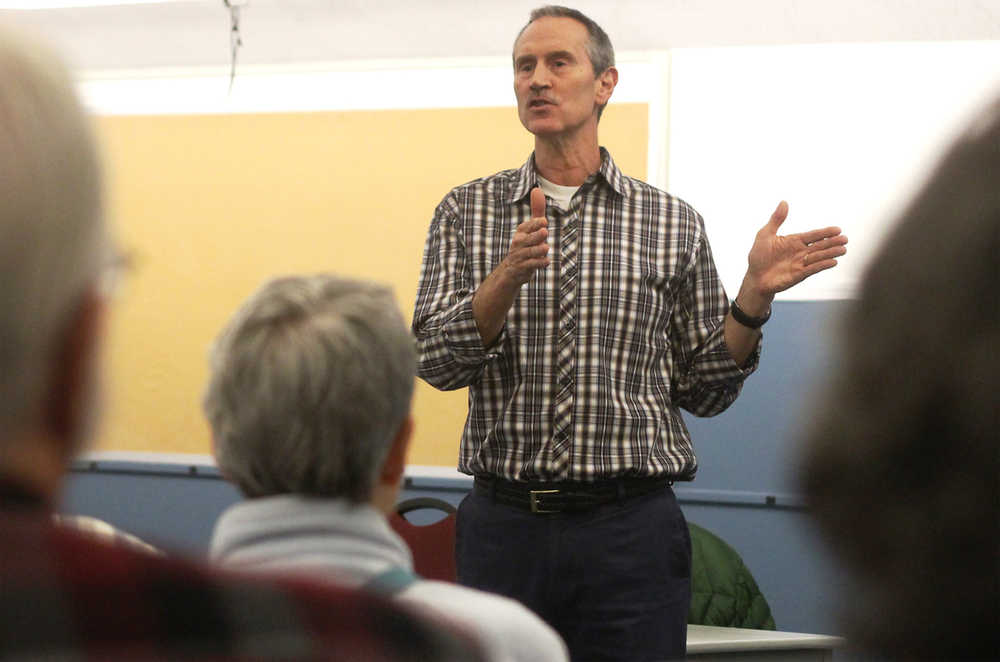 Ben Boettger/Peninsula Clarion Borough Planning Director Max Best speaks about the AK LNG Project's Kenai Spur Highway relocation plans on Thursday, Jan. 21 to a crowd at the Nikiski Recreation Center.