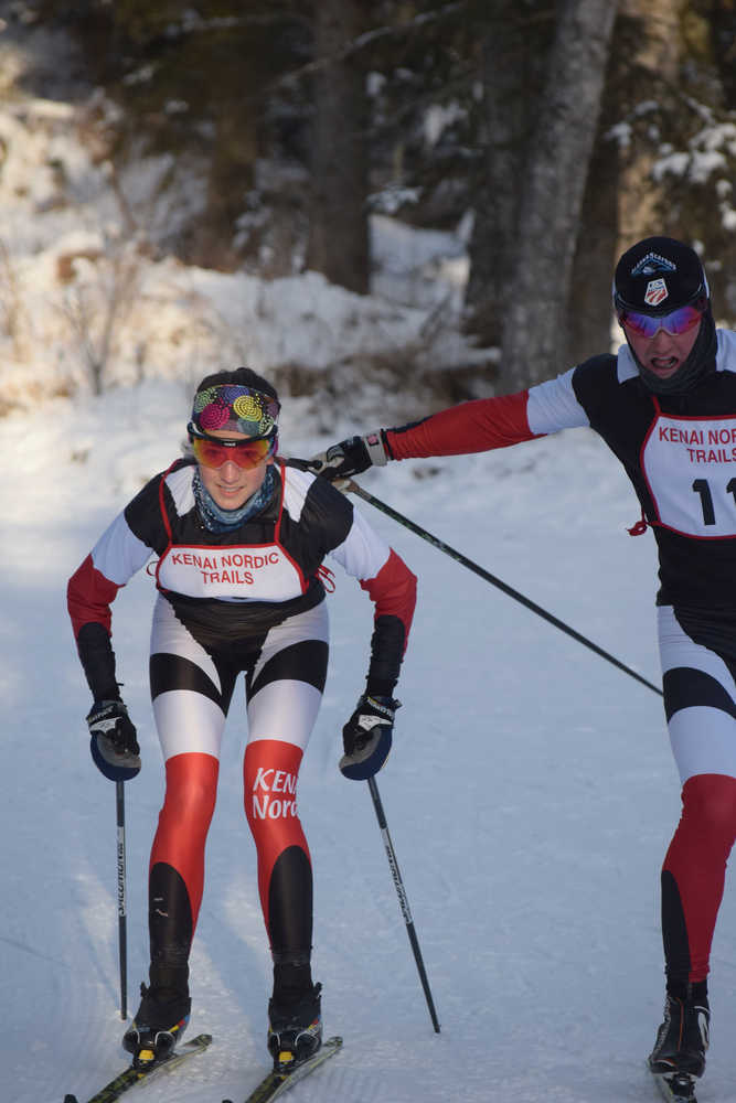 Photo by Joey Klecka/Peninsula Clarion James Butler (right) tags off to Kenai Central teammate Riana Boonstra to begin the second leg of Saturday's Kenai Klassic relays at the Tsalteshi Trails. Butler and Boonstra teamed up with Michaela Salzetti and Liam Floyd to win the 20-kilometer relay race.