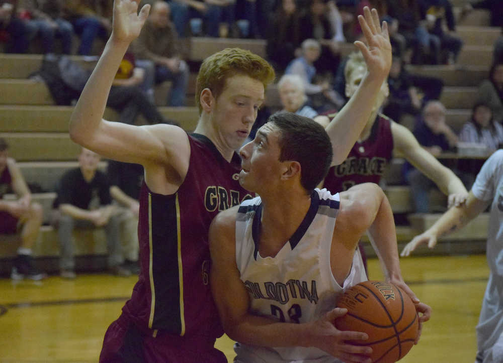 Photo by Joey Klecka/Peninsula Clarion Soldotna sophomore Derek Evans (right) drives in the lane against Grace Christian sophomore Jimmy McGovern Friday at the Soldotna Prep gymnasium. Grace defeated SoHi 56-50.