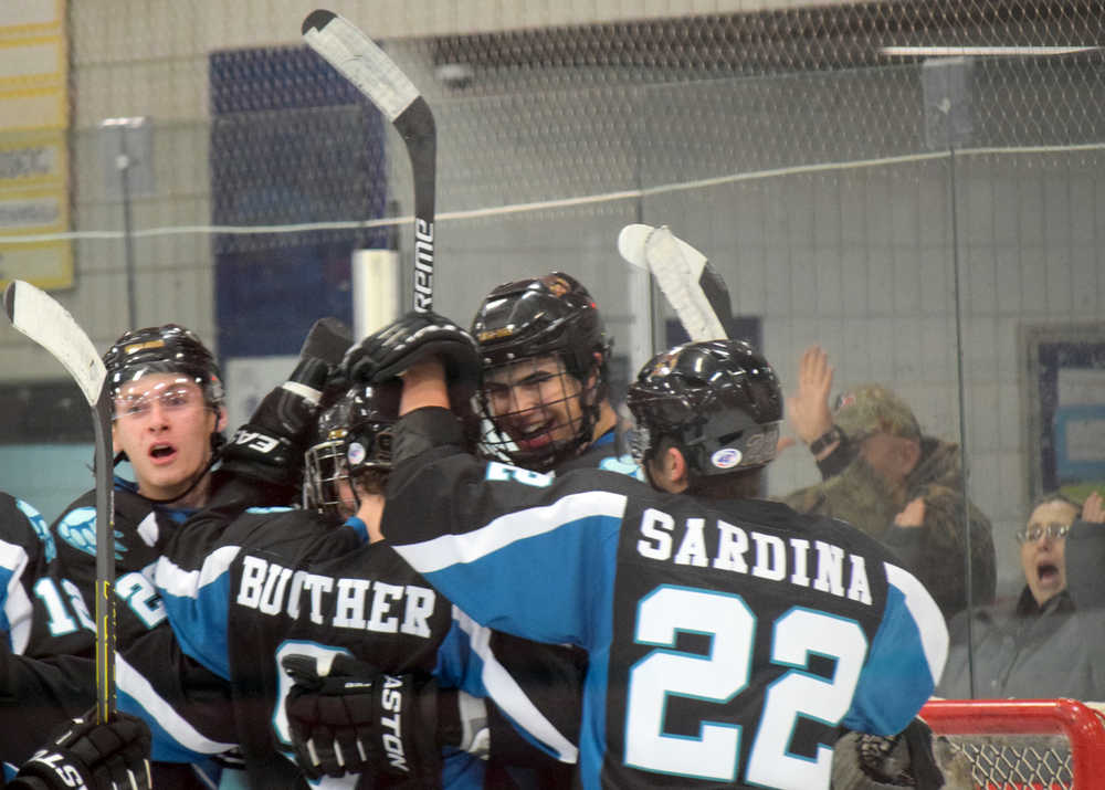 Photo by Jeff Helminiak/Peninsula Clarion Austin Junger, Evan Butcher, Croix Evingson and Joey Sardina celebrate the Kenai River Brown Bears' 3-2  victory over the Springfield Jr. Blues on Friday, Jan. 22, 2016, at the Soldotna Regional Sports Complex.