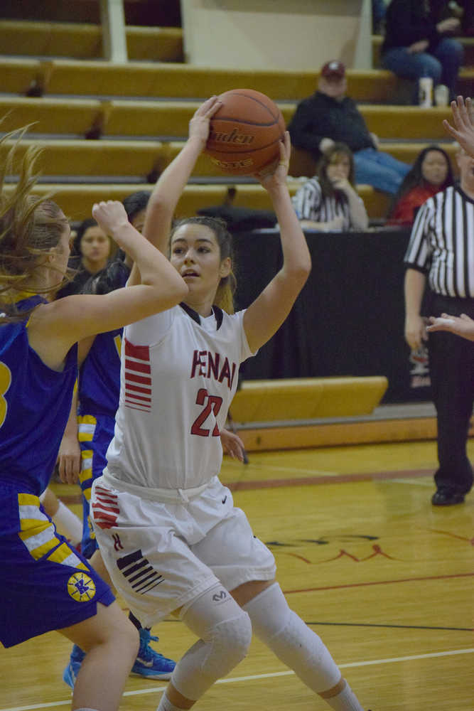 Photo by Joey Klecka/Peninsula Clarion Kenai Central senior Alexis Baker (22) looks for a shot against Kodiak forward Sydney Mutch, Saturday at Kenai Central High School. The Kardinals won 43-23.