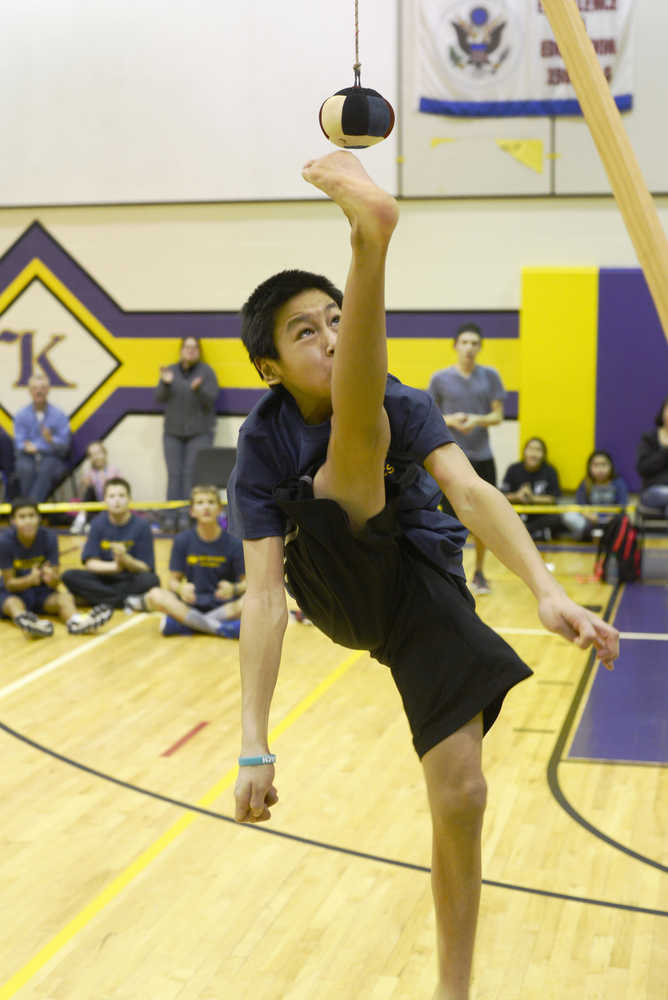 Ben Boettger/Peninsula Clarion Luke Riley attempts a one foot high kick during the Native Youth Olympics Winter Games Invitational on Saturday, Jan. 23 at Kenai Middle School. Riley barely missed making the kick.