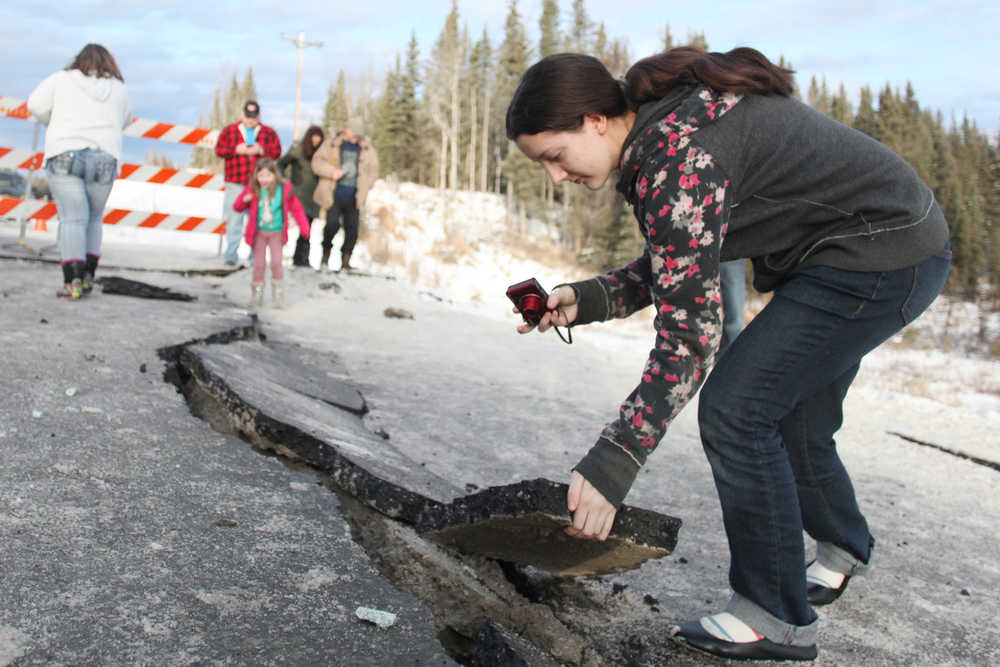 Photo by Kelly Sullivan/Peninsula Clarion Tyrrel Corveia, 14, had her parents drop her off near the 150-foot crack on Kalifornsky Beach road near Kasilof Sunday in Kasilof, Alaska. Corveia lives in a yurt and said she woke up to the structure shaking on its stilts, but said at the end her home sustained no damages.