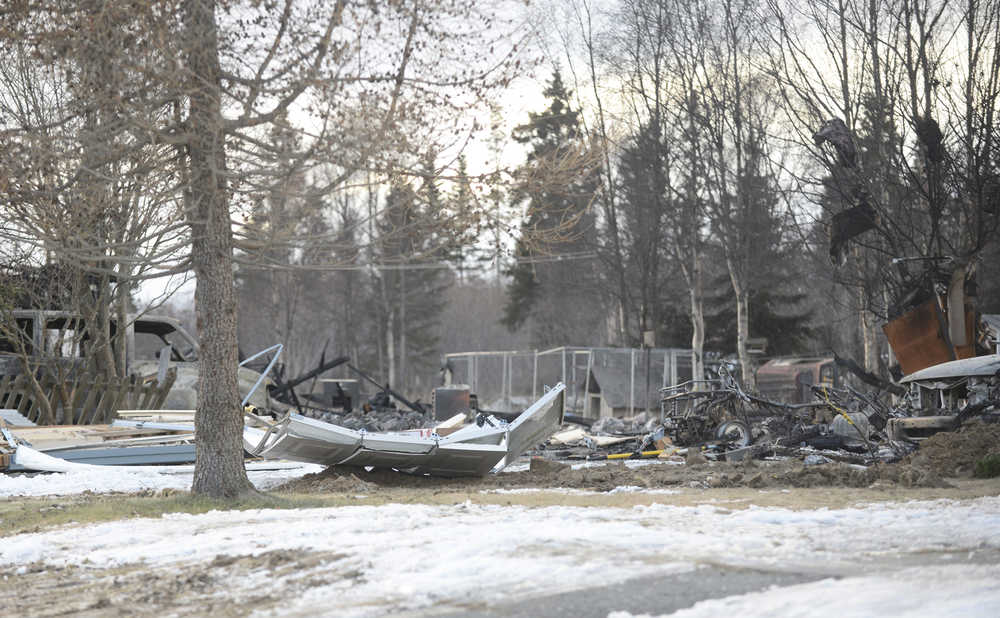 Photo by Megan Pacer/Peninsula Clarion Burnt debris litters the ground where a house used to stand on Lilac Lane on Monday, Jan. 25, 2016 in Kenai, Alaska. Gas explosions and fires took out four homes on the block following a 7.1 magnitude earthquake that hit the Lower Cook Inlet early Sunday morning.
