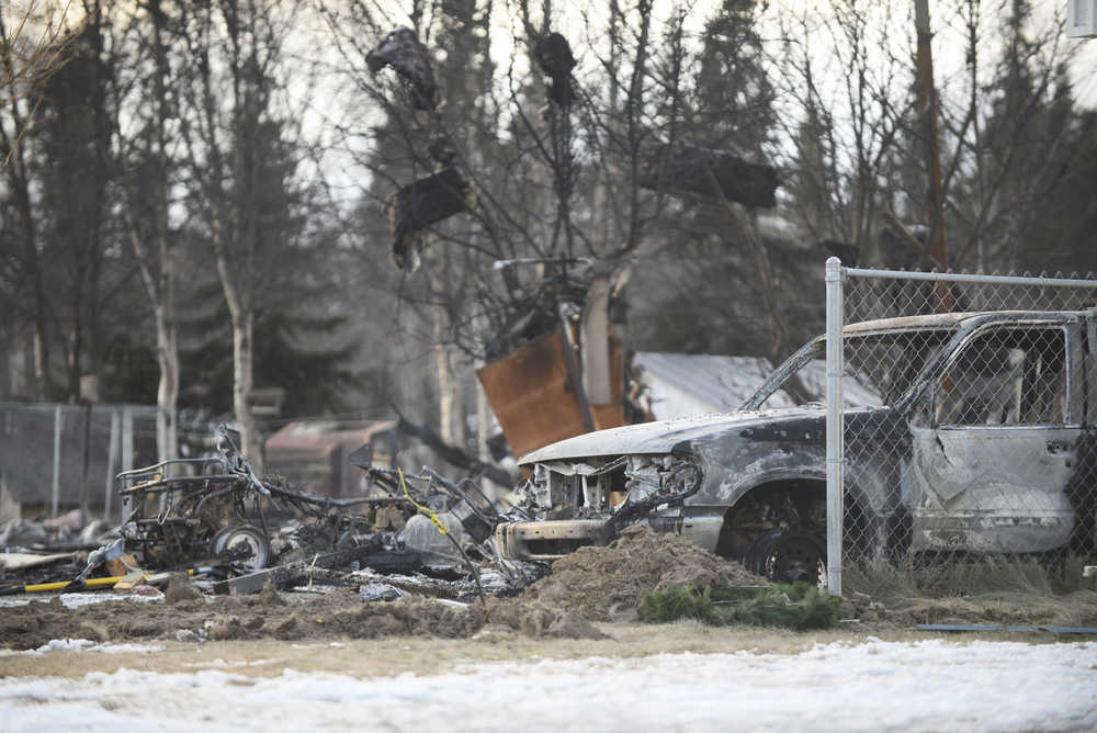 Photo by Megan Pacer/Peninsula Clarion Burnt debris litters the ground where a house used to stand on Lilac Lane on Monday, Jan. 25, 2016 in Kenai, Alaska. Gas explosions and fires took out four homes on the block following a 7.1 magnitude earthquake that hit the Lower Cook Inlet early Sunday morning.
