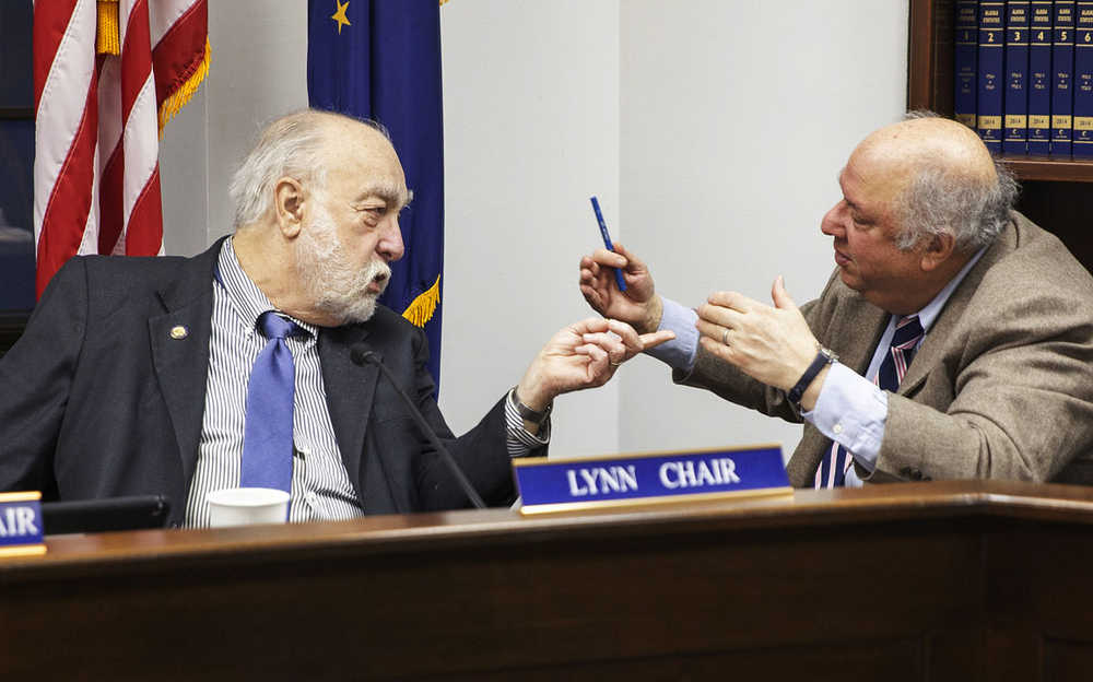 Rep. Bob Lynn, R-Anchorage and Rep. Max Gruenberg, D-Anchorage, discuss a HB 243, a measure that would allow felons whose convictions are overturned to be retroactively eligible for Permanent Fund Dividend checks, on Tuesday, Jan. 26, 2016, in Juneau, Alaska. Lynn introduced the bill after learning of the plight of a group of indigenous men known as the Fairbanks Four whose convictions were overturned after they spent 18 years in jail for the 1997 death of a Fairbanks teenager.  A condition of their release was that they would not sue government entities. (AP Photo/Rashah McChesney)