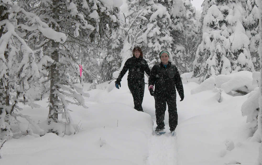Gretchen Kraus and Julie English traverse the snowshoe trail at Tsalteshi Trails in Soldotna on Dec. 22, 2013. (Clarion file photo)