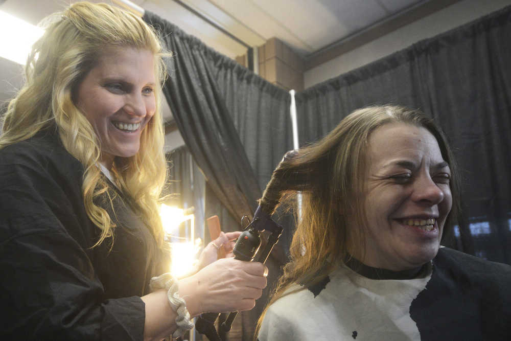 Ben Boettger/Peninsula Clarion Volunteer hairdresser Joy Conner (left) curls the hair of Alison Alley during Project Homeless Connect, an event at which local individuals and organizations provided information and services to the Kenai Peninsula's homeless population on Thursday, Jan. 28. Haircuts, massages, food, and veterinary care were among the services offered.