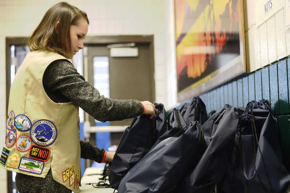 Ben Boettger/Peninsula Clarion Girl Scout Catie Kline arranges some of the 200 "comfort kits" she assembled to distribute to visitors at the Project Homeless Connect event on Thursday, Jan. 28 at the Soldotna Regional Sports Complex. The kits contained hygiene products, gloves, hats, and snacks.
