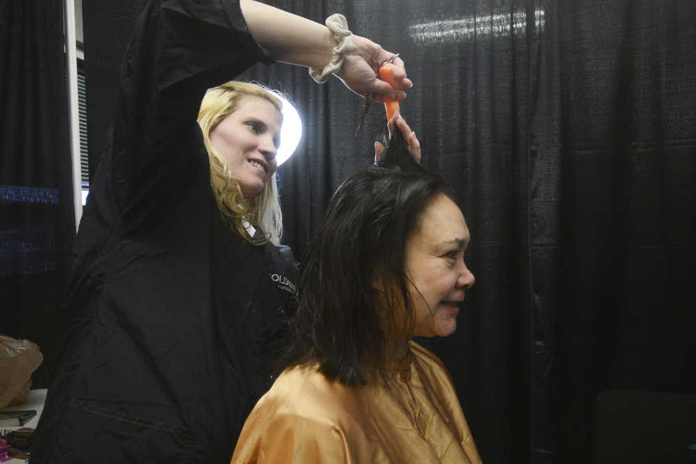 Photo by Megan Pacer/Peninsula Clarion Sandra Groller, of Kasilof, gets a haricut from Joy Conner, of Soldotna, while at Project Homeless Connect on Thursday, Jan. 28, 2016 at the Soldotna Regional Sports Complex in Soldotna, Alaska.