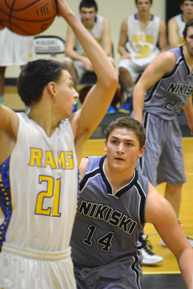 Photo by Jeff Helminiak/Peninsula Clarion Nikiski's Luke Johnson plays defense on Monroe Catholic's Will Justice on Friday at Nikiski High School.