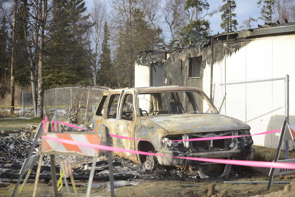 Photo by Megan Pacer/Peninsula Clarion A destroyed car rests on the lot where a house once stood on Sunday, Jan. 31, 2016 on Lilac Lane in Kenai, Alaska. Two homes exploded and another two caught on fire after a 7.1 magnitude earthquake rocked the Kenai Peninsula on Jan. 24.