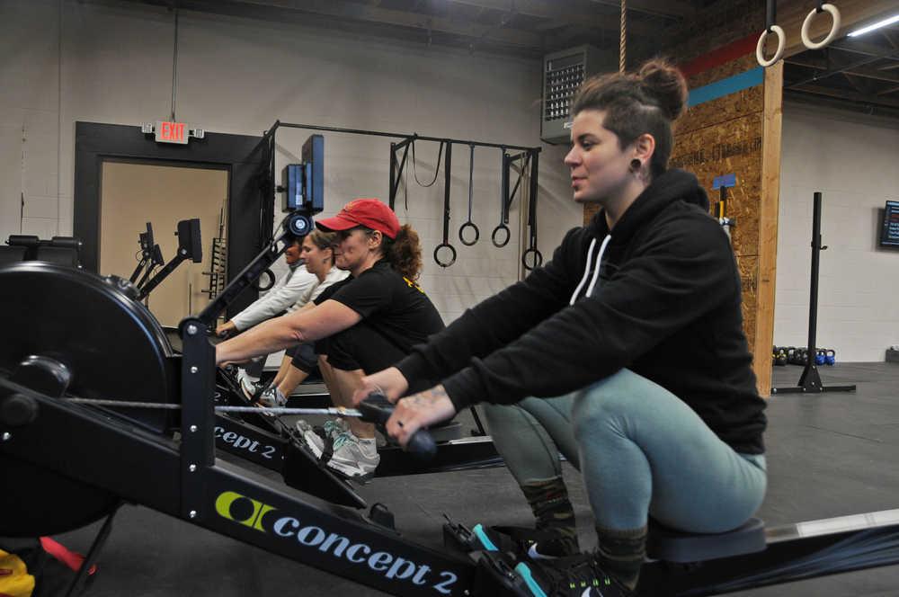Photo by Elizabeth Earl/Peninsula Clarion (From right) Brittany Jackson, the co-owner of CrossFit Kainos, rows with Nancy Saylor, Lauri Winslow and Becki Metz on Monday. Saylor and Winslow, members of the Alaska Midnight Sun Rowing Association, coach rowing classes Mondays and Wednesdays at the gym, located next to Beemun's Variety in Soldotna.