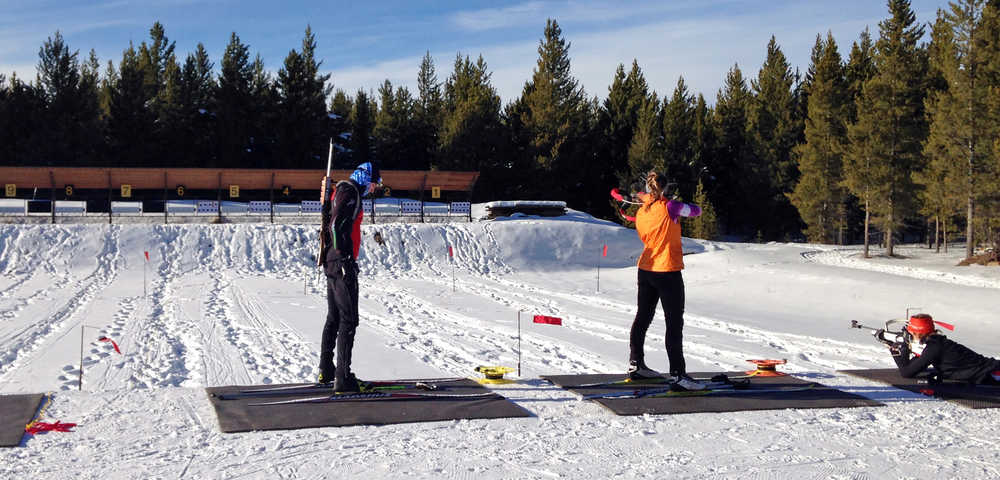 In this photo taken Nov. 23, 2015, biathlon racers practice on the firing range at the West Yellowstone Rendezvous Ski Trails center, in West Yellowstone, Mont. Cross country skiing is a full-body activity that places demands on arms, shoulders, legs, core and lungs, and racers must also master the art of picking the perfect ski wax to match snow conditions. Biathlon requires all of those skills, but adds an 8-pound rifle that's strapped to the skier's back and the discipline to calm everything down in an instant to fire off five shots in between skiing laps. (AP Photo/Martha Bellisle)