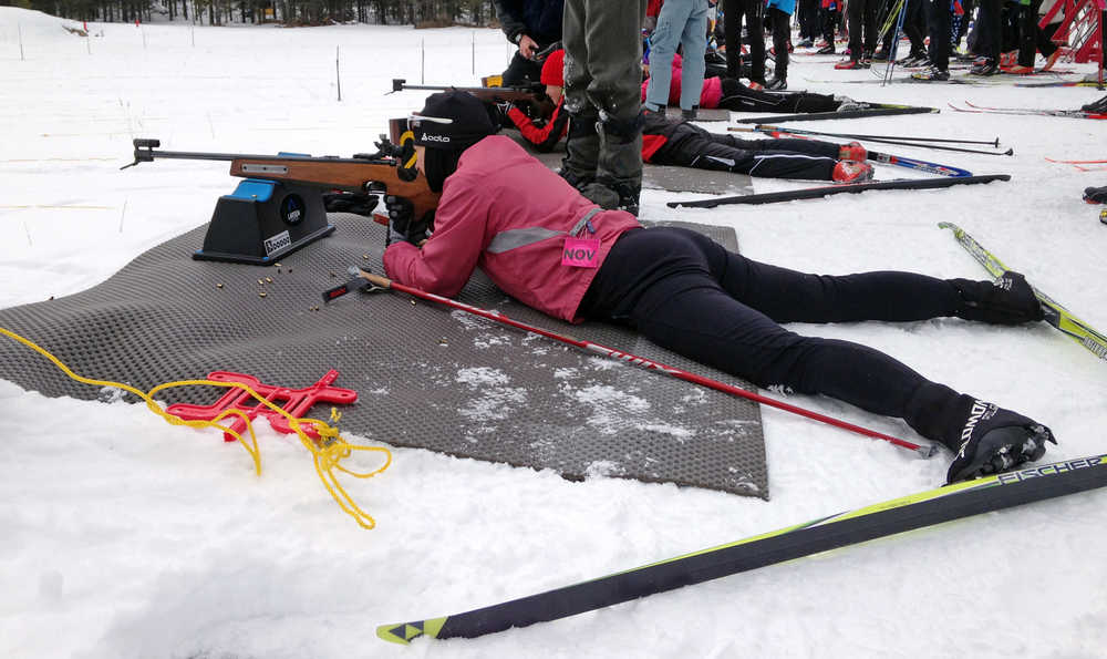 In this photo taken Nov. 23, 2015, Associated Press reporter Martha Bellisle takes her first rifle shots during a "Try-It Biathlon" clinic at the West Yellowstone Rendezvous Ski Trails center, in West Yellowstone, Mont. Cross country skiing is a full-body activity that places demands on arms, shoulders, legs, core and lungs, and racers must also master the art of picking the perfect ski wax to match snow conditions. Biathlon requires all of those skills, but adds an 8-pound rifle that's strapped to the skier's back and the discipline to calm everything down in an instant to fire off five shots in between skiing laps. (AP Photo)