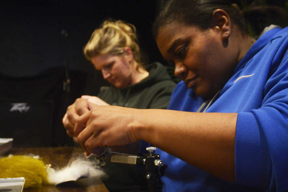 Photo by Megan Pacer/Peninsula Clarion LaDonna McCray, right, and Amber Mullican, left, work on their respective flies during a workshop hosted by the Trout Unliminted Kenai Peninsula Chapter and Soldotna's Sportsman's Warehouse on Tuesday, Feb. 3, 2016 at the Main Street Tap and Grill in Kenai, Alaska.