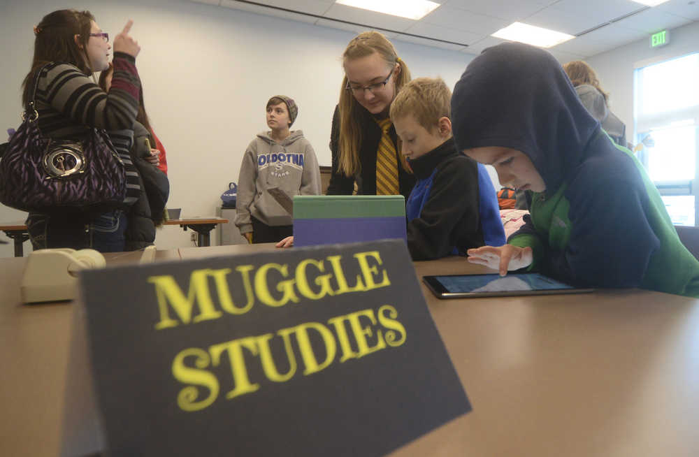 Photo by Megan Pacer/Peninsula Clarion Parker Richards, 8, prepares to test his knowledge with a trivia game during a Harry Potter Book Night event on Thursday, Feb. 4, 2016 at the Soldotna Public Library in Soldotna, Alaska.