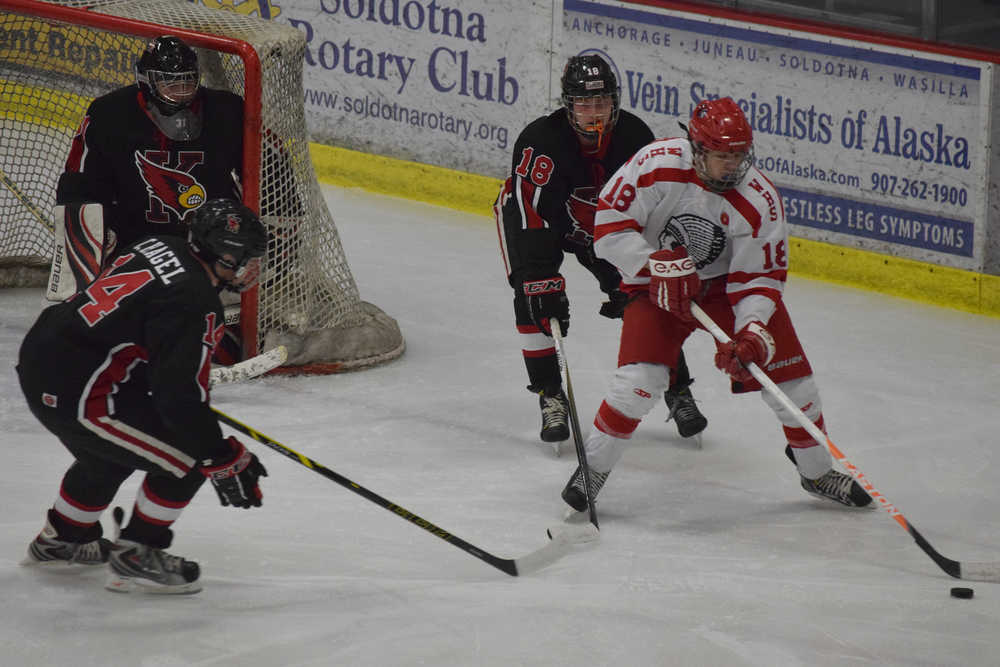 Photo by Joey Klecka/Peninsula Clarion Wasilla junior Garrett Conroy (18) is chased by Kenai sophomore Jakeb O'Brien (18) and senior Chris Hagel (14) Thursday at the North Star Conference tournament at the Soldotna Regional Sports Complex.