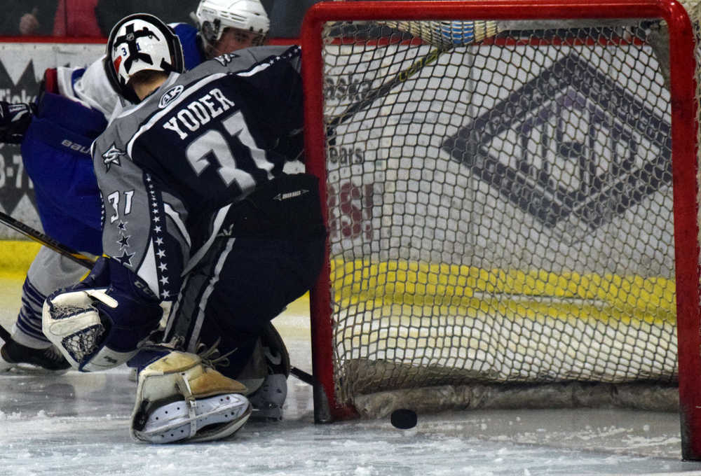 Photo by Jeff Helminiak/Peninsula Clarion The puck squirts behind Soldotna goalie Billy Yoder, but Soldotna was able to clear it off the line before a goal was scored Friday at the North Star Conference hockey tournament at the Soldotna Regional Sports Complex.