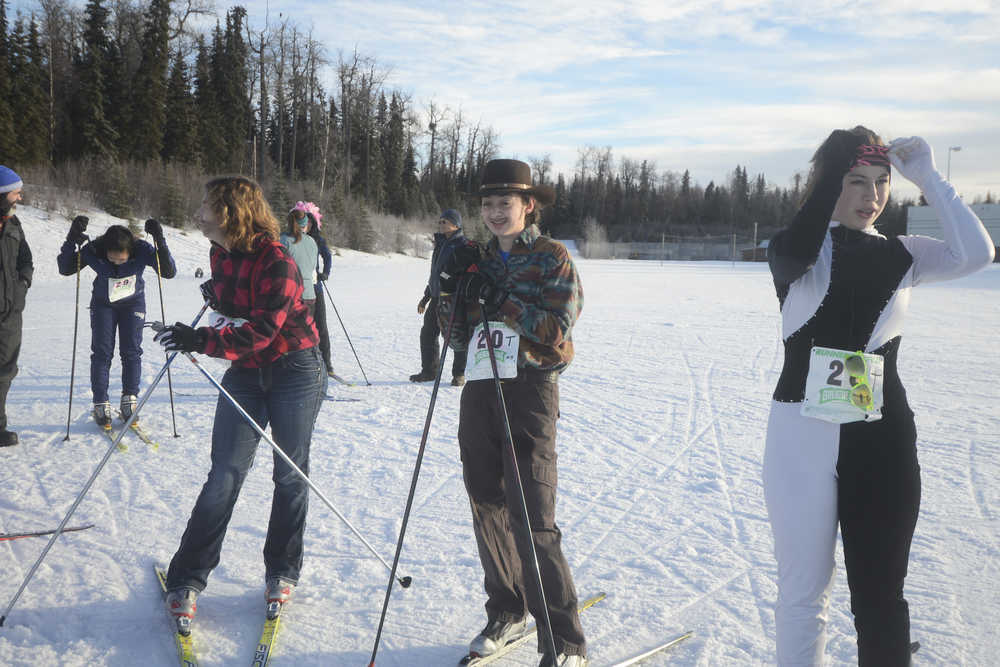 Photo by Megan Pacer/Peninsula Clarion From left to right: 18-year-old Madeleine Michaud, 18-year-old Mikaela Salzetti and 14-year-old Charly Morton take a breather after completing the Women's Stud Run 5K race on Sunday, Feb. 8, 2016 at the Tsalteshi Trails in Soldotna, Alaska. Formerly the Ski for Women, this year's Stud Run was altered to accommodate lack of snow, and partipants could choose to ski, run or snowshoe.