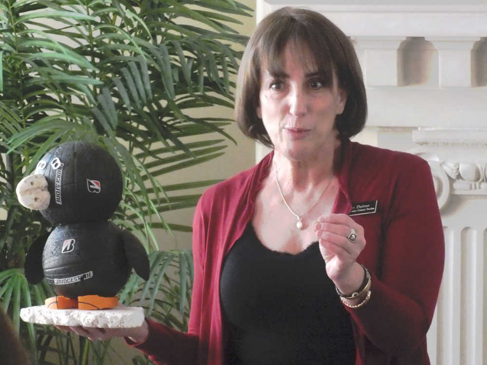 Melanie Dufour, marketing director of the Center for Alaskan Coastal Studies, presents a penguin figure made of recovered coastal debris while talking about her group's shoreline cleanup work at the Soldotna Chamber of Commerce Luncheon on Tuesday, Feb. 9 at Froso's Restaurant in Soldotna.