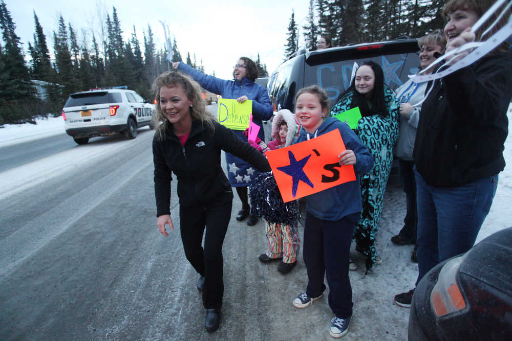 Photo by Kelly Sullivan/ Peninsula Clarion Families gathered at the entrance of the Soldotna High School parking lot to see off the Soldotna Stars hockey team, which headed to Class 4A State Hockey Tournament Wednesday, Feb. 10, 2016, in Soldotna, Alaska. Once the departing convoy was out of sight, the group dashed back into their cars to follow the player's school bus that was being escorted by the Central Emergency Services and Soldotna police and fire departments. The school beat out the top ranked team in Alaska to secure a spot in the state tournament, said mother Katie Olson.