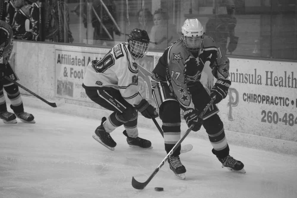 Photo by Joey Klecka/Peninsula Clarion Soldotna junior Levi Hensley (17) looks for a scoring opportunity on the Colony Knights, as Colony sophomore Foster Riekena looks on. Soldotna faces the Chugiak Mustangs in today's first round of the Class 4A state hockey tournament.