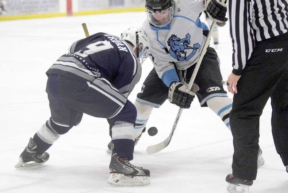 Photo by Joey Klecka/Peninsula Clarion Soldotna junior Jace Urban fights for the puck on a faceoff against Chugiak senior Cody Curfman at Thursday's Class 4A state hockey tournament quarterfinal at the Curtis Menard Sports Complex in Wasilla.