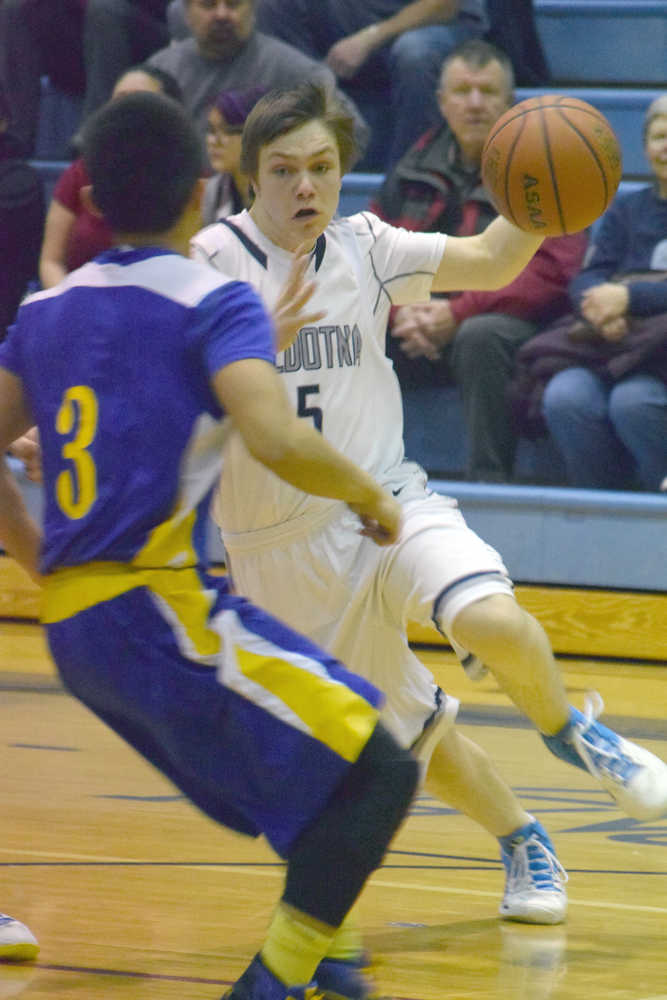 Photo by Jeff Helminiak/Peninsula Clarion Soldotna's Eli Sheridan drives on Kodiak's Billy Alcaide on Friday at Soldotna High School.