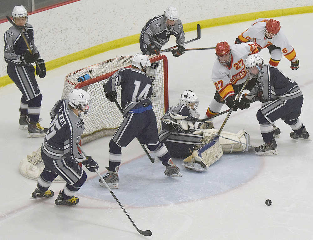 Photo by Joey Klecka/Peninsula Clarion Soldotna junior Matthew Daugherty (15), freshman Wyatt Harvey (14), sophomore Billy Yoder and junior Jace Urban watch as the puck rebounds away from the net in Friday's 4A state hockey tournament consolation semifinal at the Curtis Menard Sports Complex in Wasilla. West Valley beat Soldotna 7-1.