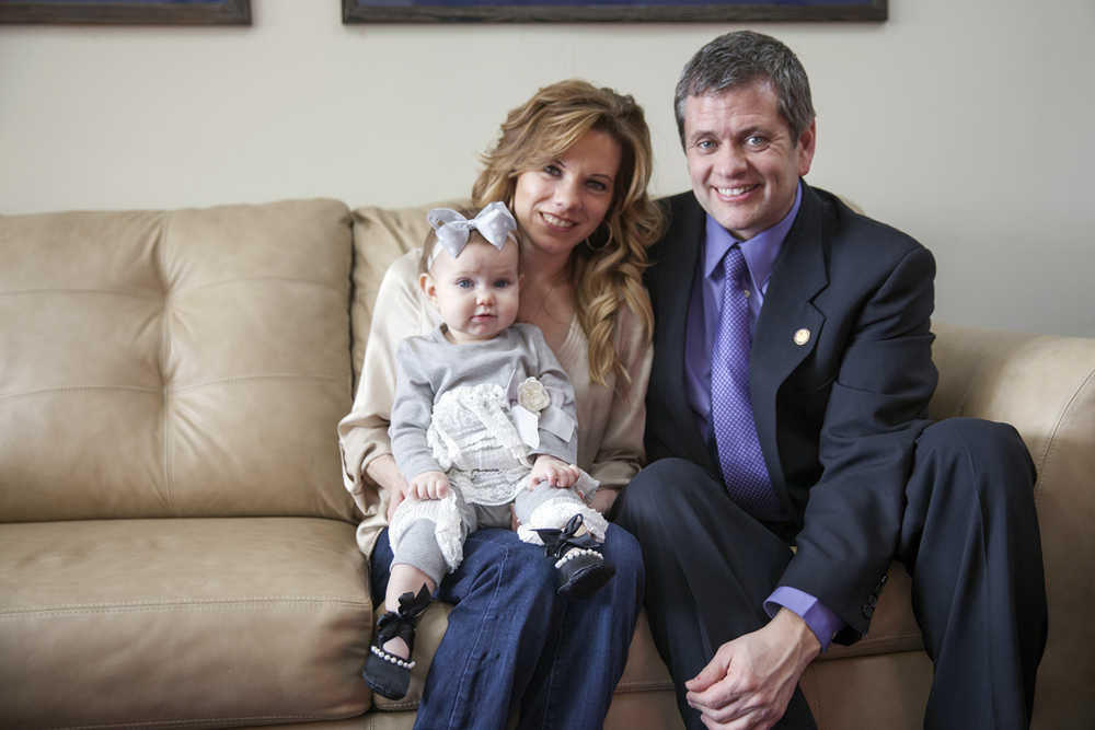 In this Feb. 5, 2016 photo, Bernadette Wilson, daughter Penelope Grace Tuck and partner Rep. Chris Tuck, D-Anchorage, pose for a photo in Tuck's office in Juneau, Alaska. Alaska House Democrats have regained prominence after years of wielding limited influence, with their support expected to be critical to passing a budget this session. Their leader is Tuck, whom colleagues see as well-suited for the job: a union organizer with a disarming laugh and a willingness to hear people out. (AP Photo/Rashah McChesney)