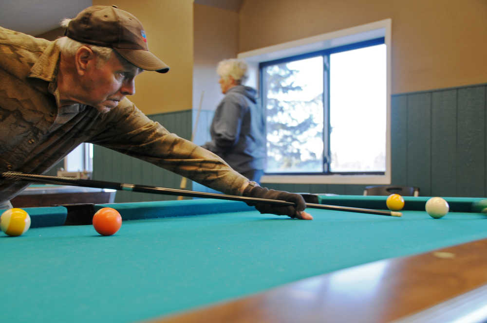 Photo by Elizabeth Earl/Peninsula Clarion Jerry Norris of Soldotna, Alaska lines up a shot at the Kenai Recreation Center during the annual Senior Olympics on Tuesday, Feb. 16, 2016.
