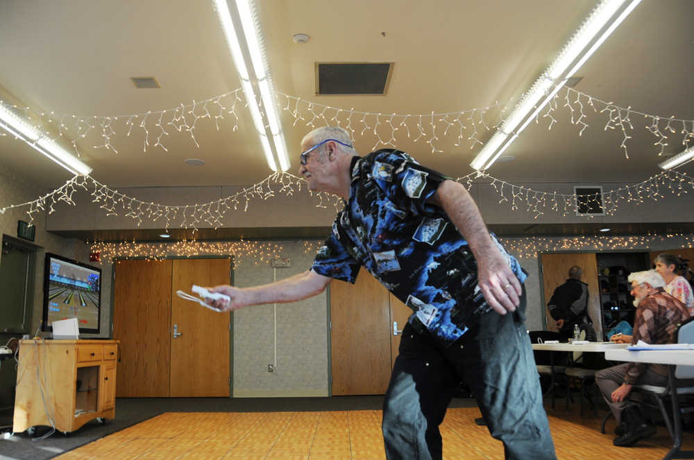 Photo by Elizabeth Earl/Peninsula Clarion Denny Thomas takes a swing at the Wii Bowling event of the Senior Olympics at the Kenai Senior Center Tuesday, Feb. 16, 2016.