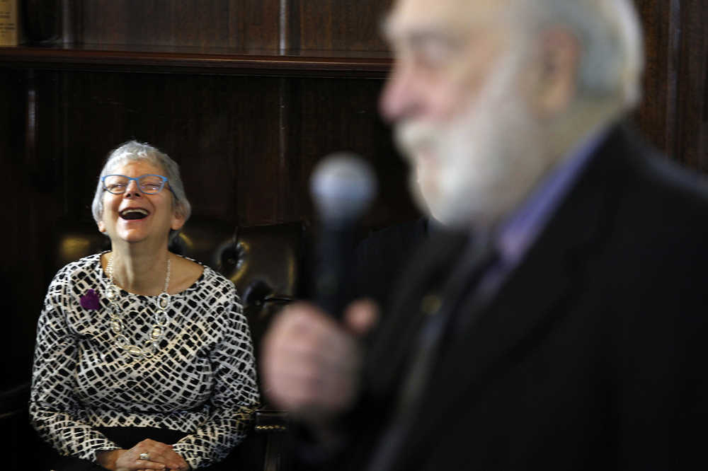 CORRECTS SECOND REFERENCE TO GRUENBERG - Kayla Epstein laughs as Rep. Bob Lynn, R-Anchorage, talks about his memories of her late husband Rep. Max Gruenberg, during a memorial on Tuesday, Feb. 16, 2016, in Juneau, Alaska. Gruenberg died suddenly on Sunday. (AP Photo/Rashah McChesney)