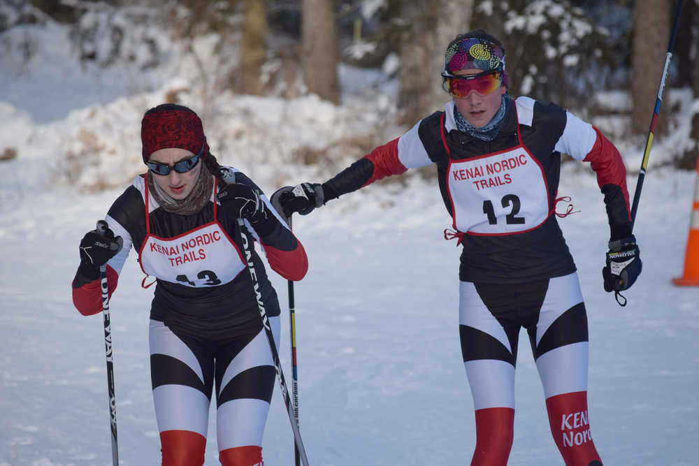 Photo by Joey Klecka/Peninsula Clarion Kenai Central sophomore Riana Boonstra (12) tags off to senior teammate Michaela Salzetti (13) at the Kenai Klassic relay races Jan. 22 at the Tsalteshi Trails in Soldotna.