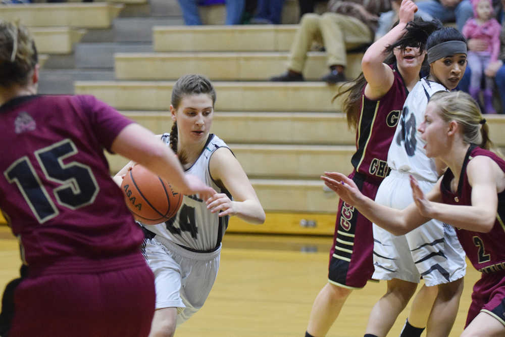 Photo by Joey Klecka/Peninsula Clarion Nikiski freshman Kelsey Clark (24) drives to the post Thursday at Nikiski High School in a Southcentral Conference clash against Grace Christian.