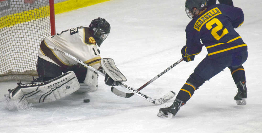 Photo by Jeff Helminiak/Peninsula Clarion Springfield Jr. Blues defenseman Anthony Scarsella scores the game-winning goal in the shootout on Kenai River Brown Bears goalie Nick Nast on Friday at the Soldotna Regional Sports Complex.