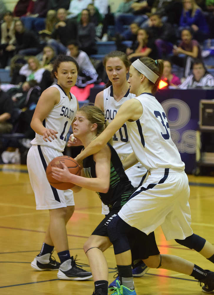 Photo by Joey Klecka/Peninsula Clarion Colony guard Amanda Smith (center) is mobbed by Soldotna defenders (left to right) Lindsey Wong, Aliann Schmidt and Danica Schmidt Saturday at Soldotna High School. The Knights defeated the Stars 43-25.