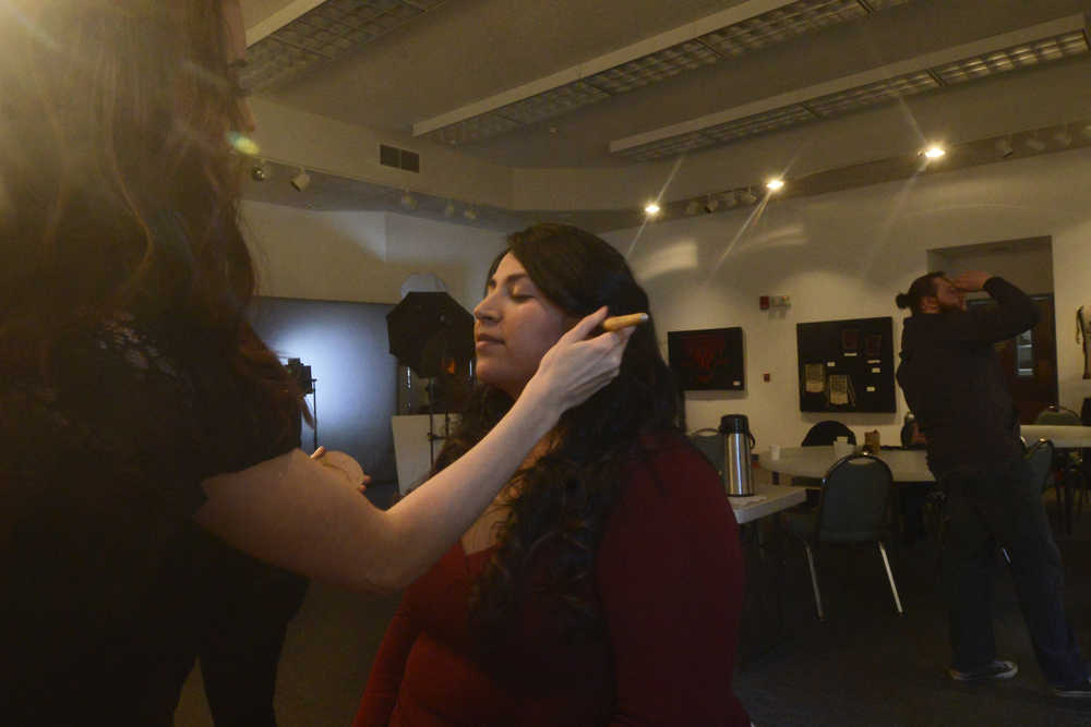 Kasilof resident Vanessa Perry patiently waits while her makeup is applied by Jasmin McGahan before a photoshoot on Monday, Feb. 22, 2016 at the Kenai Chamber of Commerce and Visitor Center in Kenai, Alaska. Perry was one of about 20 participants who showed up to take advantage of "Fresh Look February," an event hosted by the Kenai Young Professionals where group members and area residents could get professional headshots taken by Artistic Puppy Creative after a makeover by Jasmin's Hair Design. The group, which launched in December, has about 70 members so far and sees a turnout of about 35-40 people at each event, said Kenai Young Professionals Director Pamela Parker.