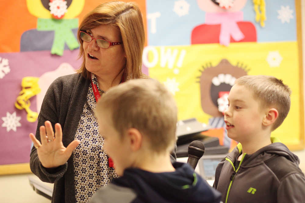 Photo by Kelly Sullivan/ Peninsula Clarion Principal Margaret Gilman walks Sam Yerkes and Bryce Dederick through how to make the morning announcements Wednesday, Feb. 24, 2016, at Nikiski North Start Elementary in Nikiski, Alaska. She said it is a very brief "20-second" training period.
