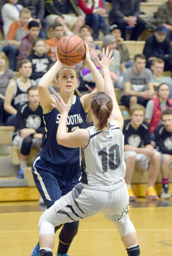 Photo by Joey Klecka/Peninsula Clarion Soldotna guard Kendra Brush shoots against Nikiski defender Hallie Riddall (10) Thursday at Nikiski High School.