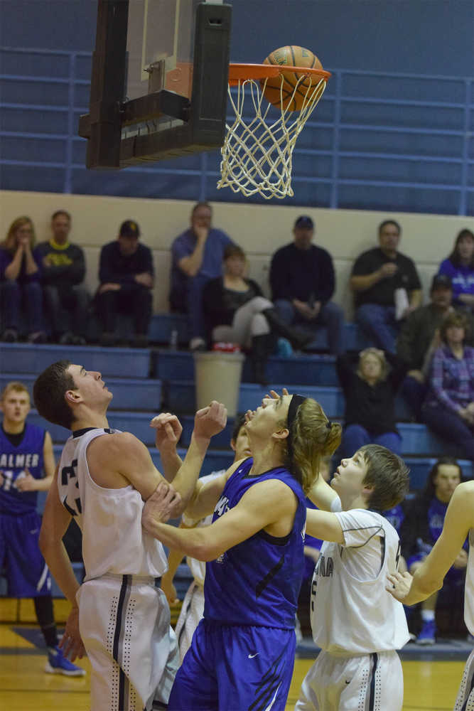 Photo by Joey Klecka/Peninsula Clarion (From left to right) Soldotna forward Derek Evans, Palmer forward Michael Kluting and Soldotna guard Eli Sheridan jostle for the ball Friday at Soldotna High School.