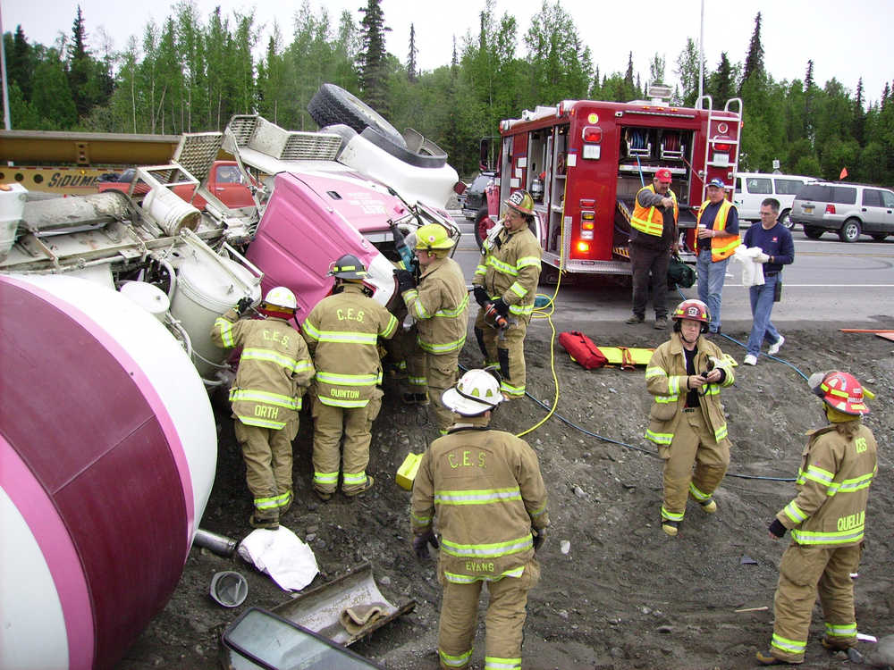 CES Captain Lesley Quelland and other first responders from CES tend to the aftermath of a cemet truck rollover on Kalifornsky Beach Road and the Sterling Highway.