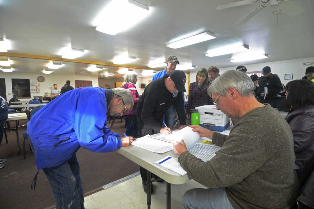 Voters at the old Nikiski Senior Center sign in to participate in the Republican Presidential Preference Poll on Tuesday, March 1, 2016.