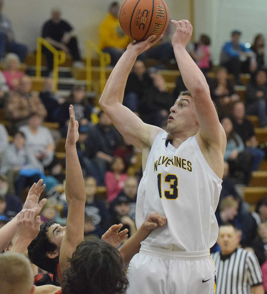 Photo by Joey Klecka/Peninsula Clarion Ninilchik guard Pat Brandt takes a shot over a crowd of Seldovia defenders in Friday night's Peninsula Conference championship game at Homer High School.