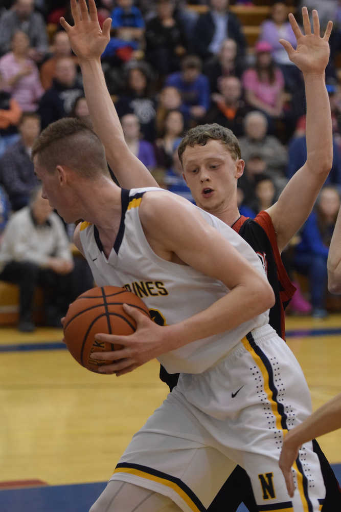 Photo by Joey Klecka/Peninsula Clarion Seldovia guard Aidan Philpot guards Ninilchik forward Austin White in Friday night's Peninsula Conference boys championship game at Homer High School.