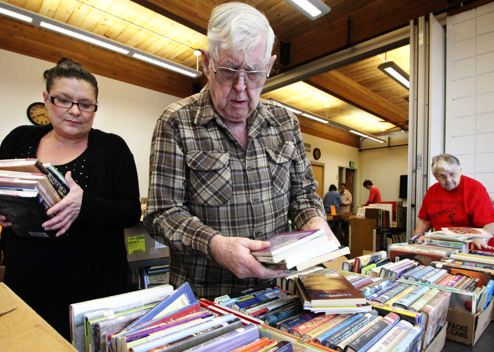 Members of the Friends of Kenai Library arrange books in preparation for their fundraising book sale on Saturday, March 5 at the Kenai Community Library's conference room. The group will sell donated books to benefit the library from March 7 to the 13th.