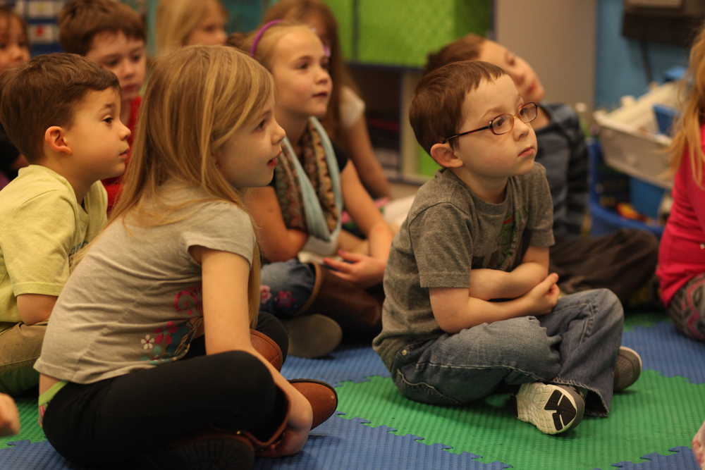 Photo by Kelly Sullivan/ Peninsula Clarion The kindergarteners in Lynne Dawson's class listened intently to Dan Grimes, deputy chief for the Central Emergency Services, read three stories for Love of Reading Month Wednesday, March 2, 2016, at Redoubt Elementary School in Soldotna, Alaska.