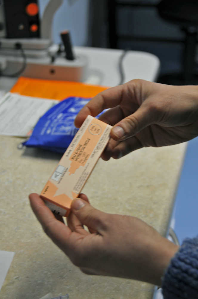 Photo by Elizabeth Earl/Peninsula Clarion Dr. Sarah Spencer, a primary care doctor at the Ninilchik Clinic in Ninilchik, Alaska, demonstrates how Naloxone would be administered. Naloxone, which can temporarily stop the effects of a drug overdose to allow an overdose patient time to get medical treatment, will be able to obtain the medication directly from pharmacists if a bill passes the Alaska Senate and is signed by the governor.