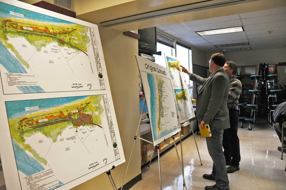 Photo by Elizabeth Earl/Peninsula Clarion Luke Randall, an engineering manager with the Alaska Division of Parks and Outdoor Recreation's Office of Design and Construction, points out details of one of the proposed concepts for the development on the north side of the Kasilof River to a community member at the open house held on Tuesday, March 8, 2016, at Tustumena Elementary School in Kasilof, Alaska.